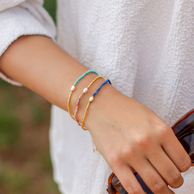 trio of white 4mm oval freshwater pearl gemstone drawstring bracelets with white and yellow gold coloured beads