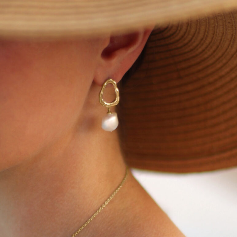 Baroque Drop Gold Pearl Earring on model with straw hat