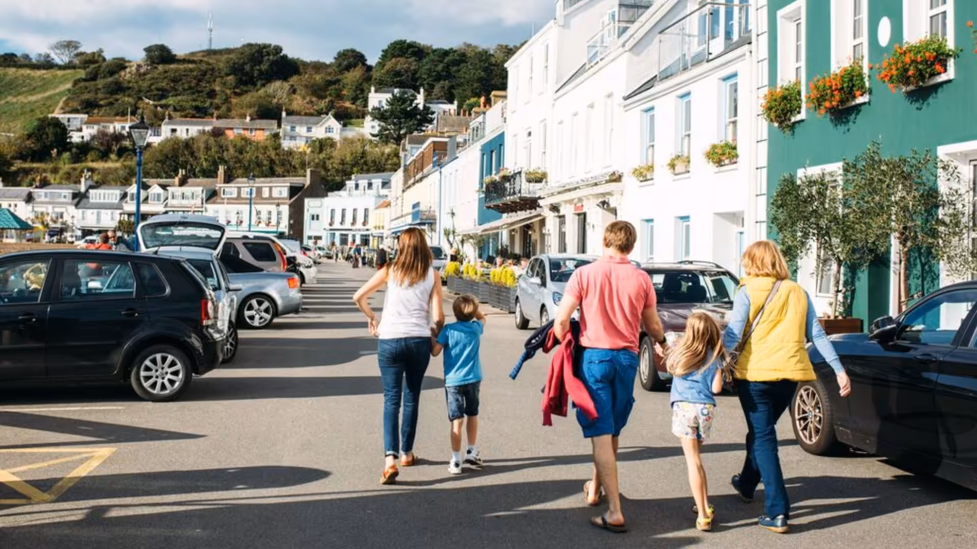 family walking in gorey jersey hand in hand past shops