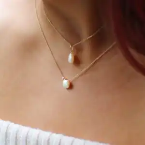 8mm white Keshi freshwater pearl 9ct yellow gold pendant paired with 8mm white Keshi freshwater pearl white topaz 9ct yellow gold necklace