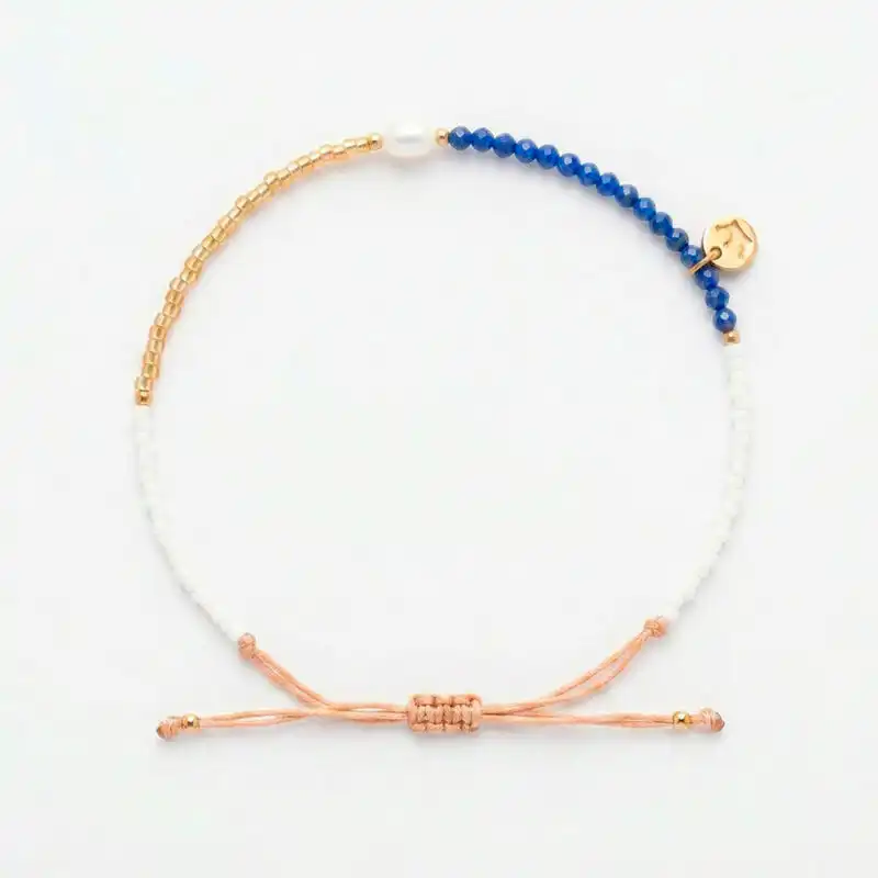 white 4mm oval freshwater pearl lapis stone drawstring bracelet with white and yellow gold coloured beads