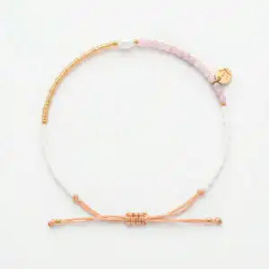 white 4mm oval freshwater pearl pink sunstone drawstring bracelet with white and yellow gold coloured beads