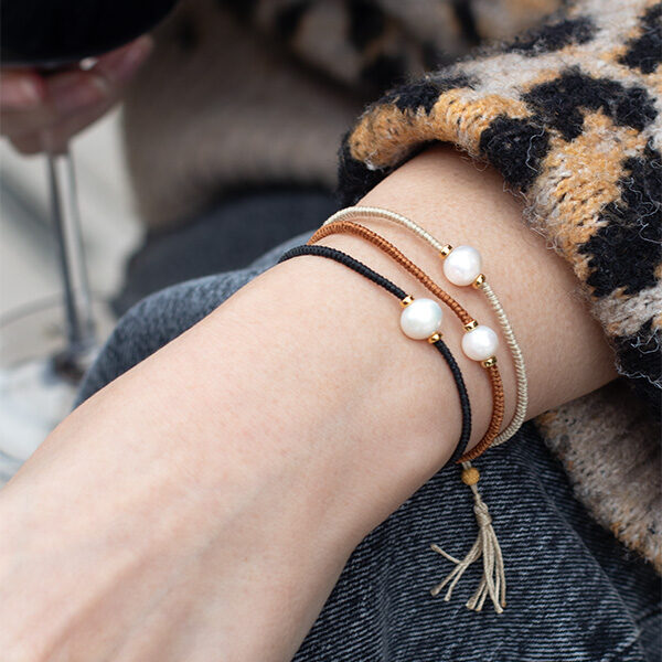 Model wearing Jersey Pearl Tassel Bracelets, Black, Tan and Daiquiri