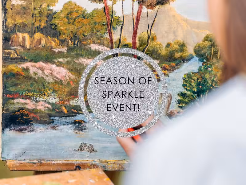 Close up of a lady painting a forrest scene
