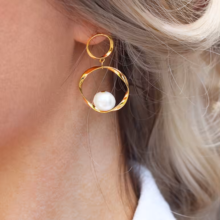 model wearing baroque double drop earrings