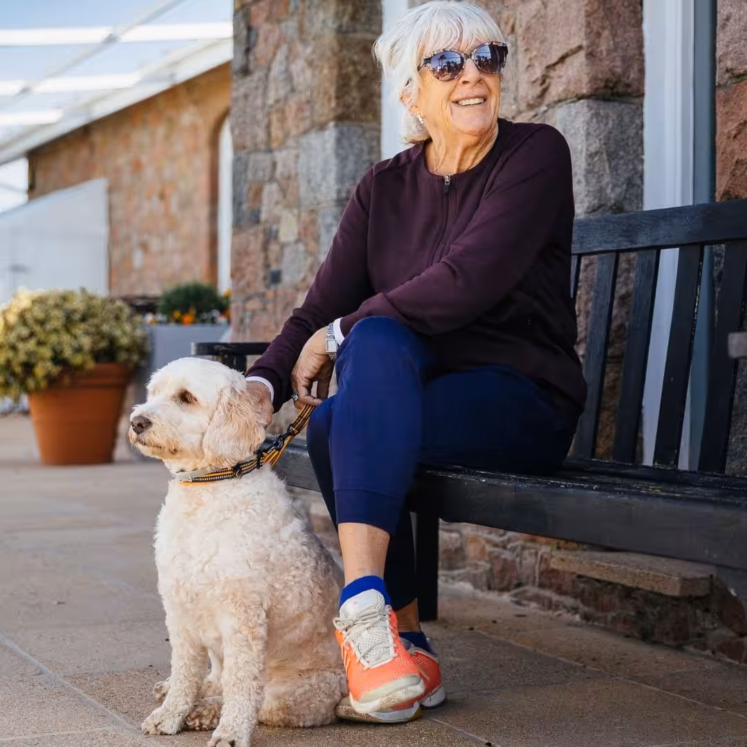 photo of a lady and her dog at jersey pearl st ouen