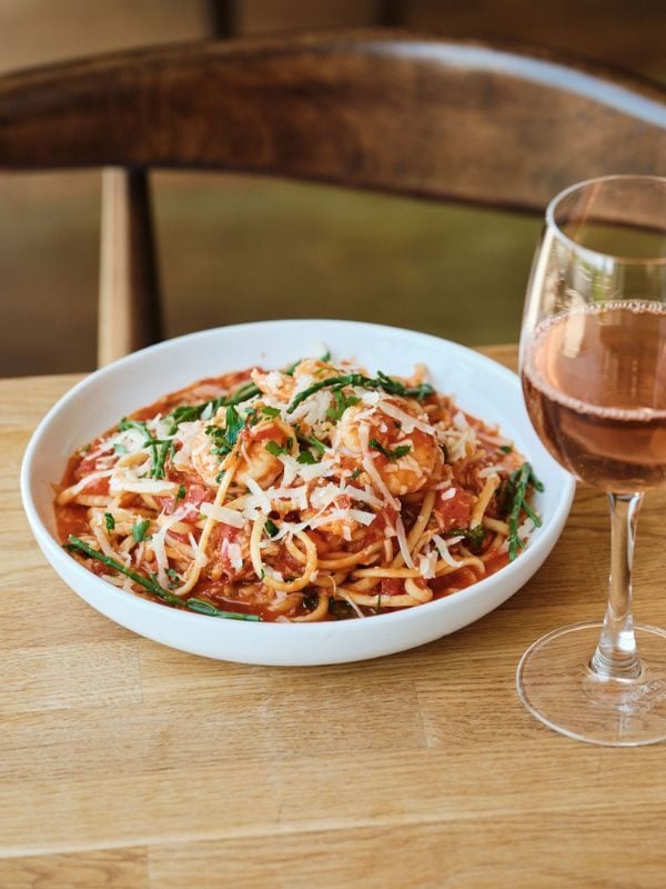Bowl of seafood spaghetti and glass of rose wine