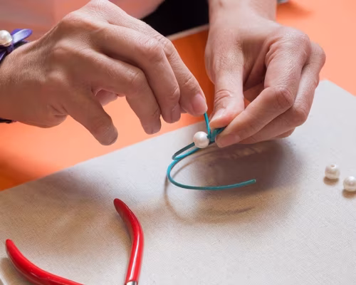 Process image of an expert threading a pearl bracelet