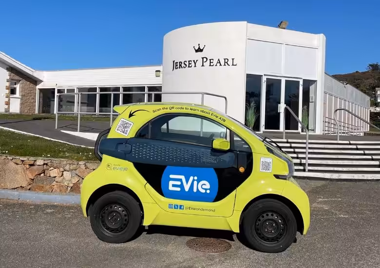 Jersey Pearl St Ouen building and an eco EVie car outside