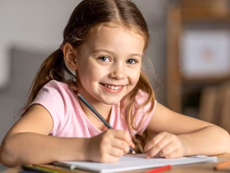 Little girl doing half term quiz and colouring in at jersey pearl