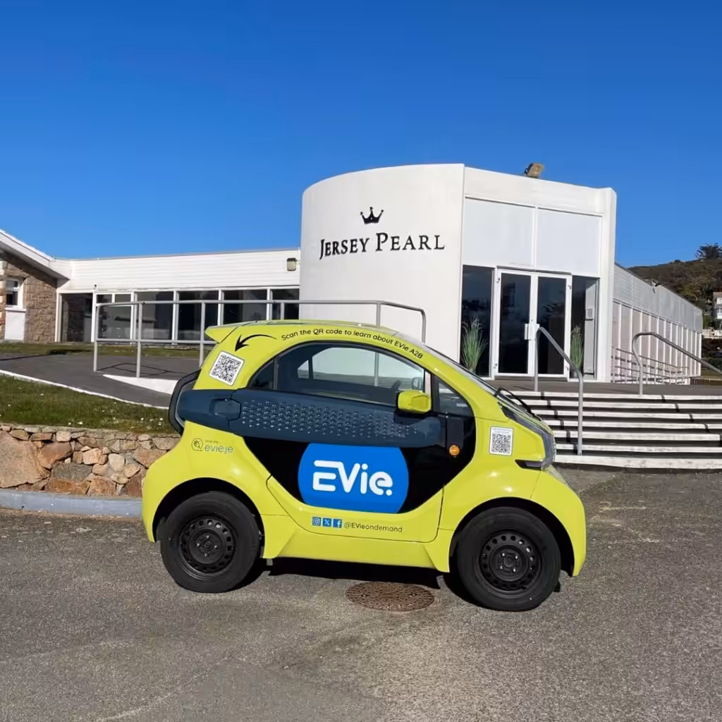 Jersey Pearl St Ouen building and an eco EVie car outside