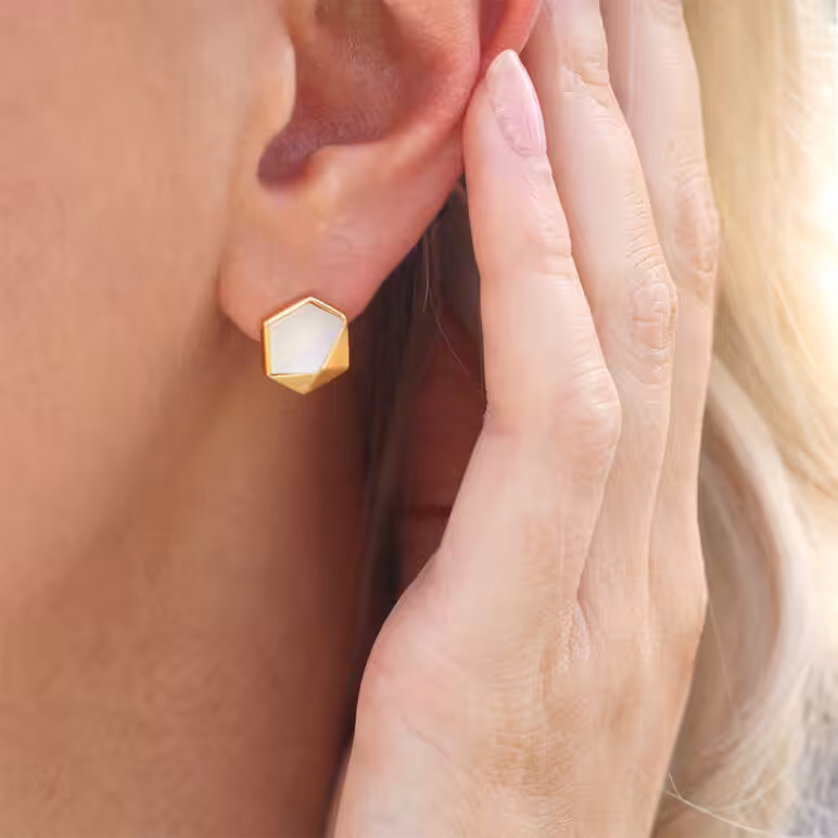 Lifestyle model wearing Kyra gold earrings