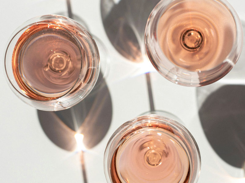 three glasses of rose wine shot from above with shadows